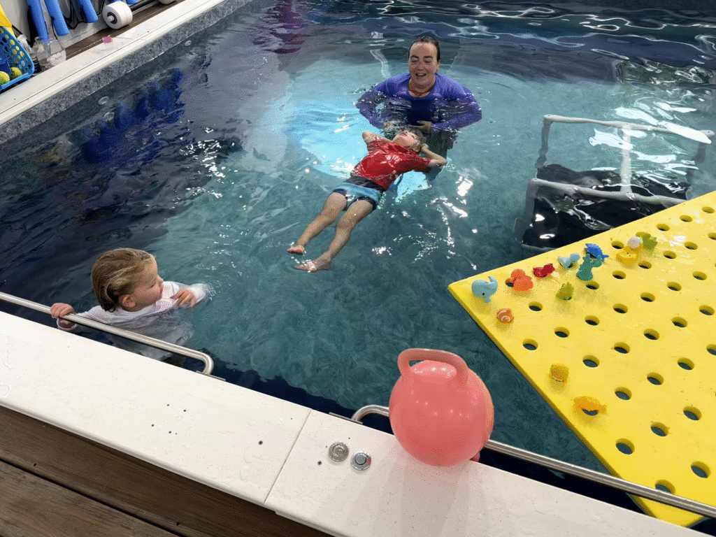 A picture of a Thistledown Swim Academy semi-private lesson with a young boy and girl