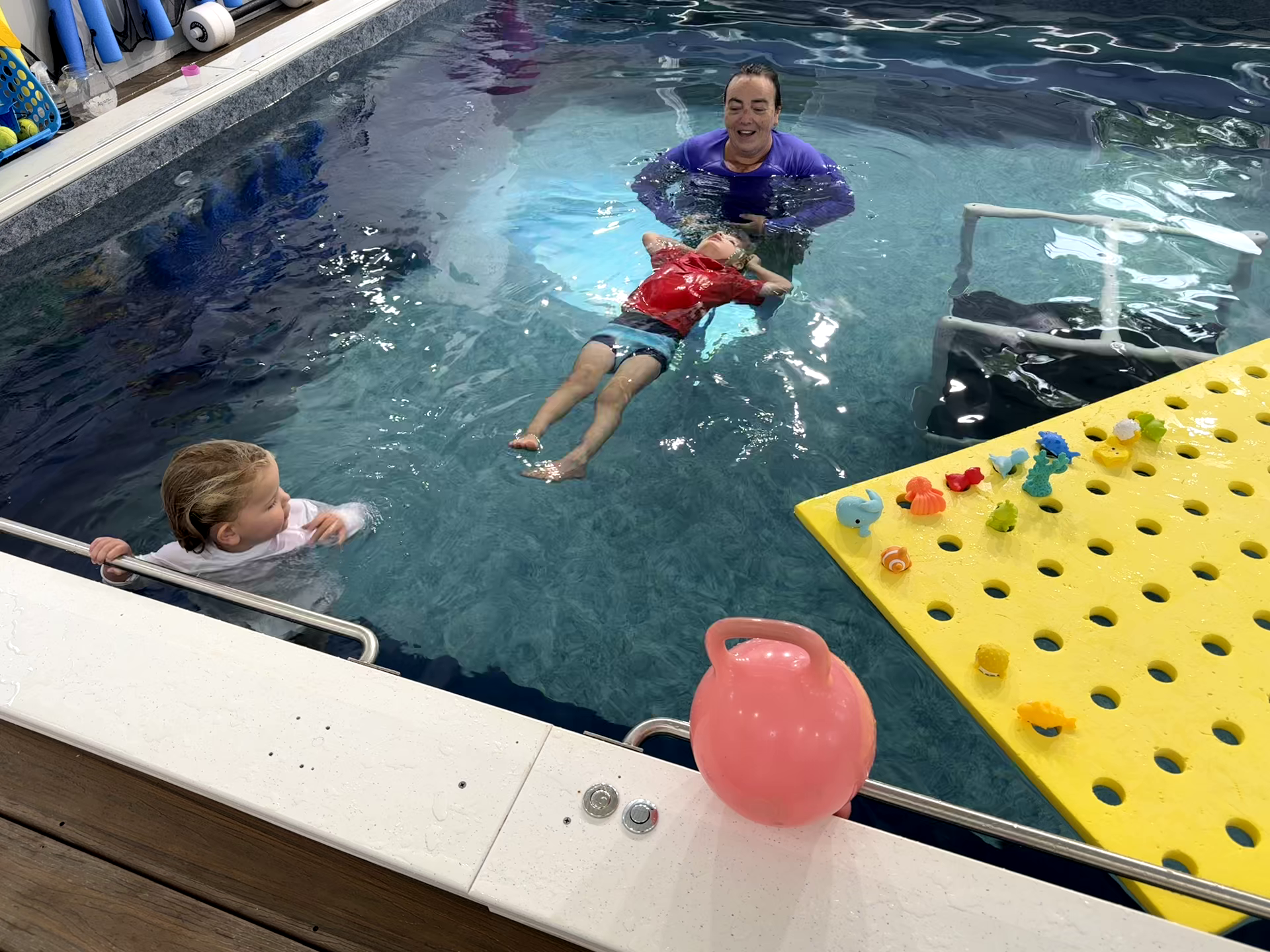 A picture of a Thistledown Swim Academy semi-private lesson with a young boy and girl
